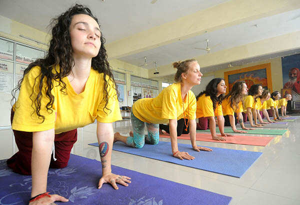 Foreigners participate in a yoga training session