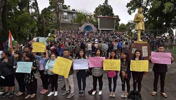 Demonstrators hold placards