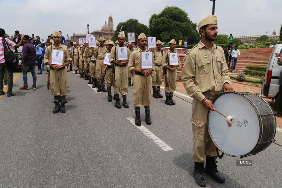 People wearing army dress marching with the actors