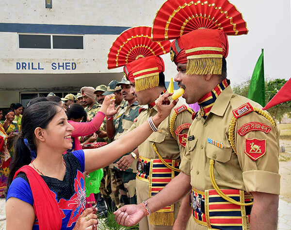 Women offering sweets to BSF personnel
