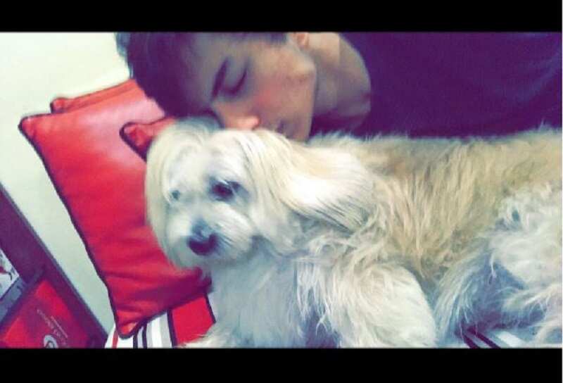 Cuddling with his pet pooch