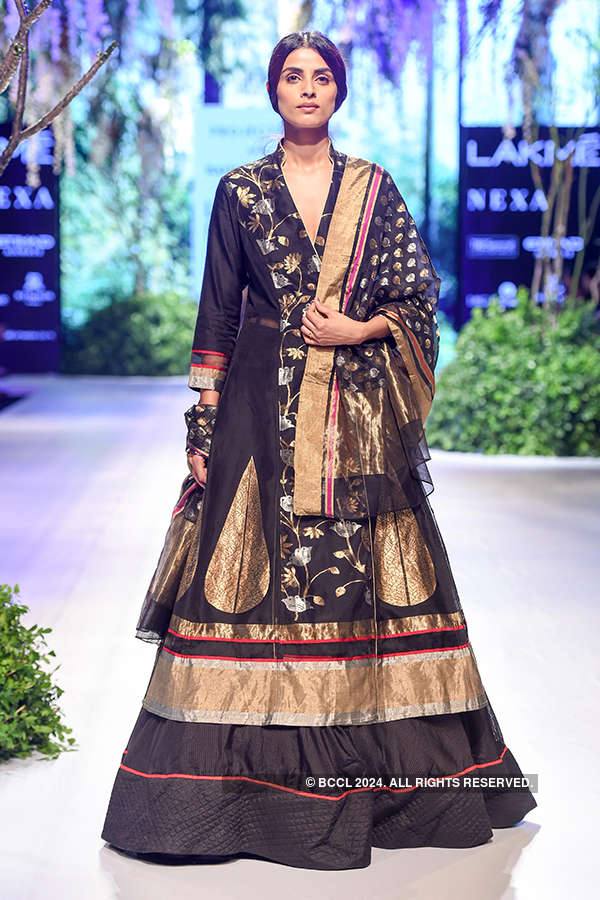 A model showcases a creation by designer Rahul Mishra on Day 3 of the ...
