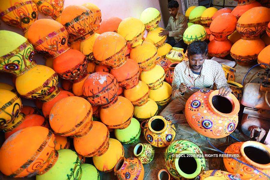 ​ An artist is busy decorating earthen pots