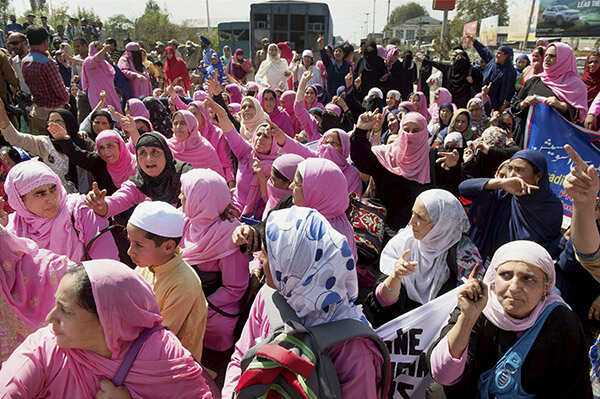 Kashmiri Anganwadi workers take part in a protest