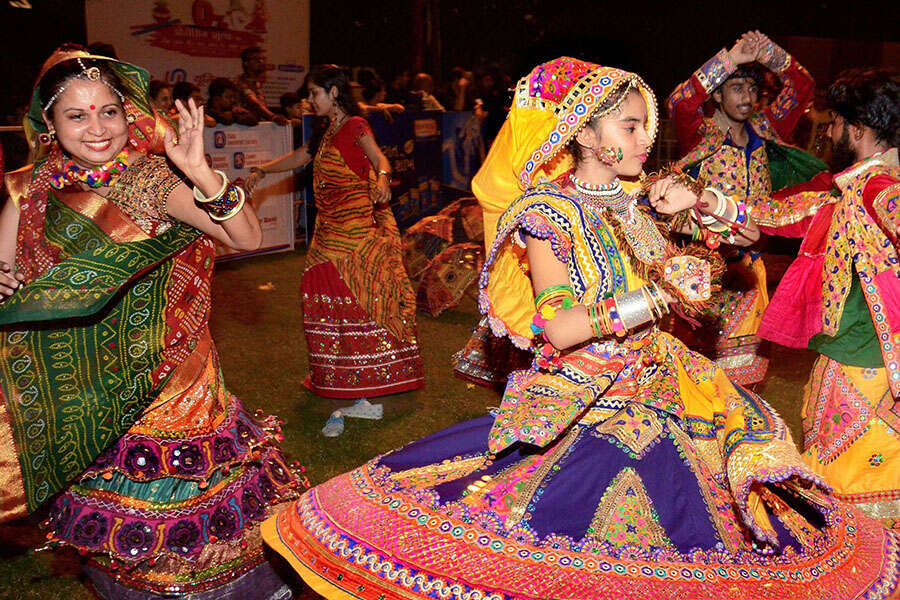 Participants, dressed in traditional attire, perform Garba