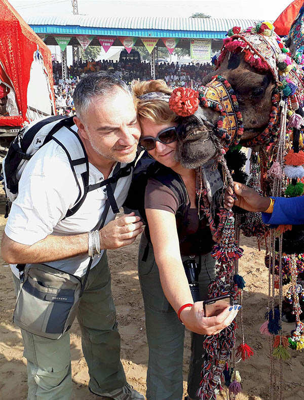 Foreign tourists taking a selfie with a came