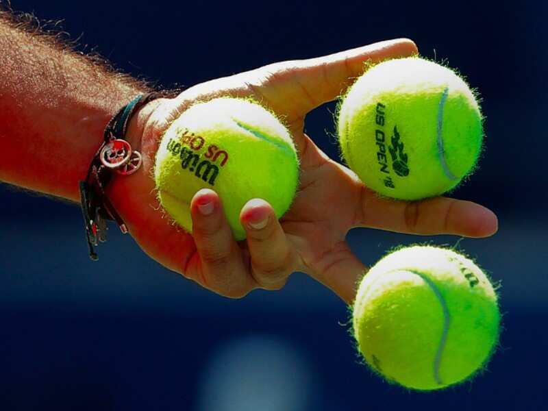 Estimate the number of tennis balls that can fit into a plane.