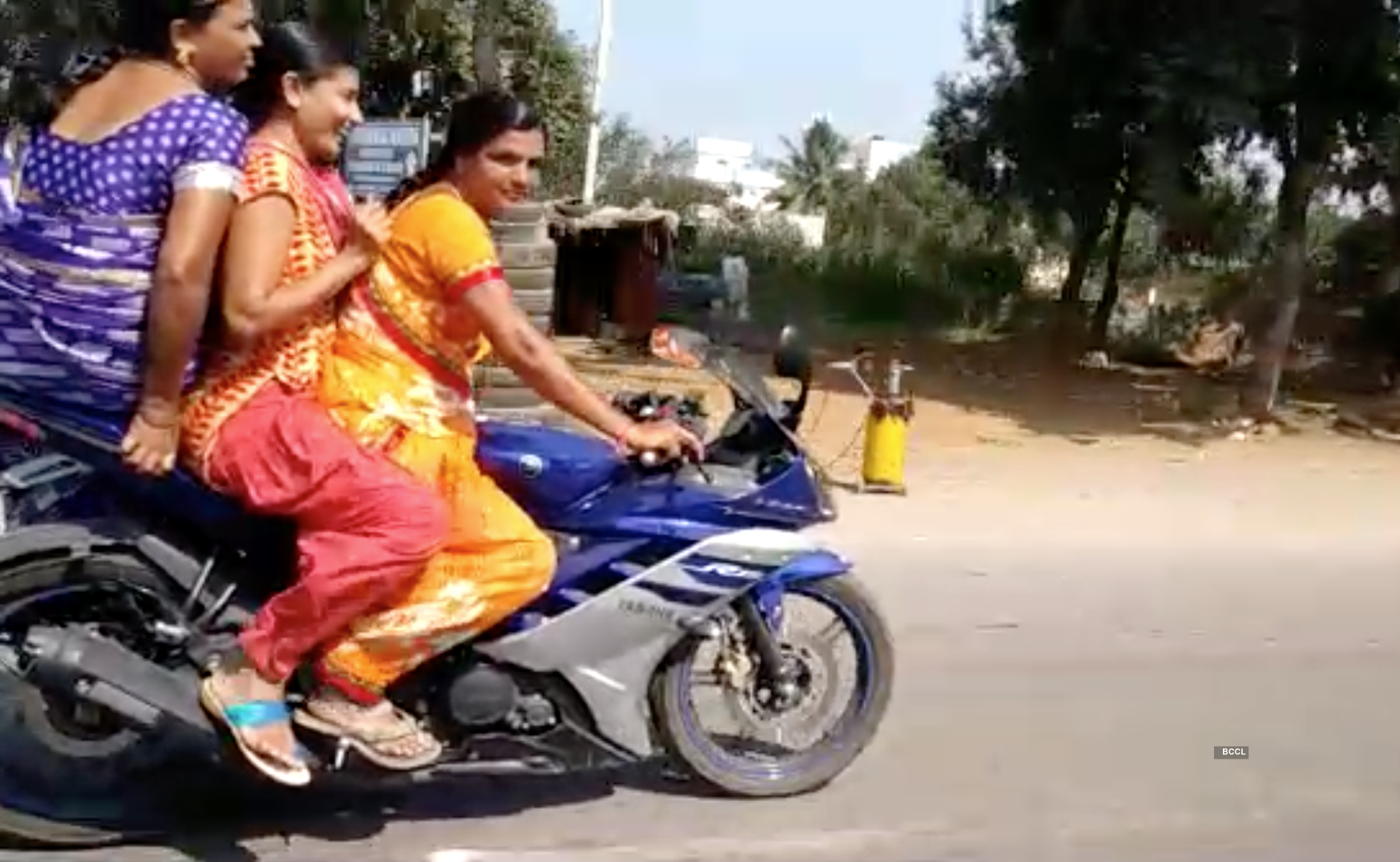 Indian woman in saree riding sports bike