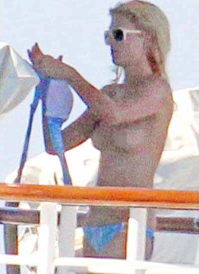 Paris Hilton goes topless on a trip