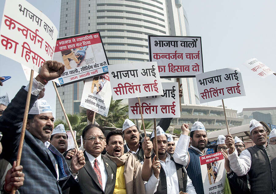 AAP members display placards while staging a protest over various ...