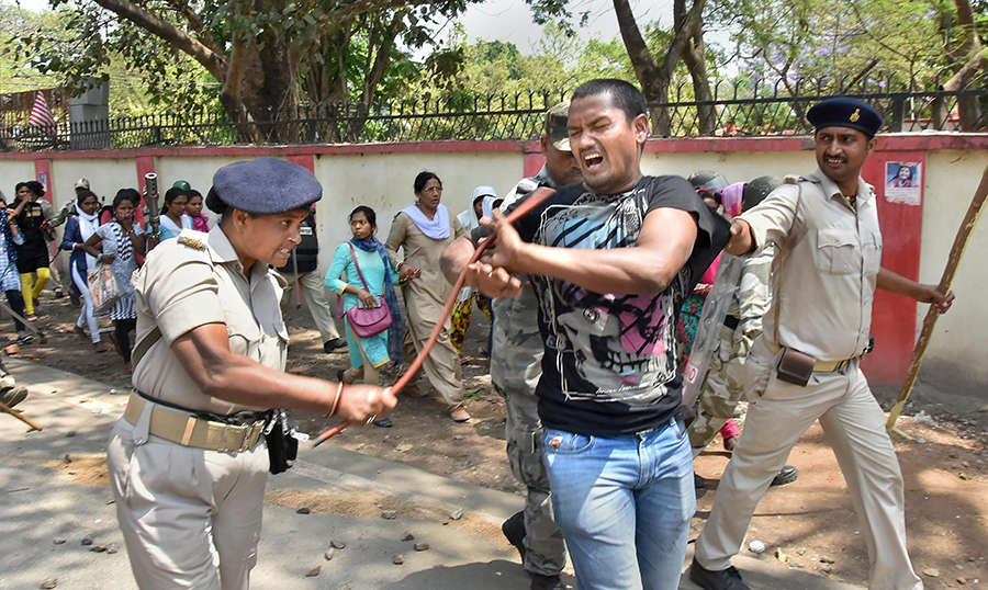 Police Beat A Protester With Batons During A Countrywide Strike Against ...