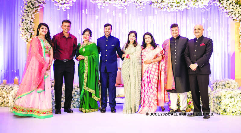 Mayank Agarwal and Aashita Sood pose with Rahul Dravid and other friends  and family members during their wedding reception held at a hotel in  Bangalore - Photogallery