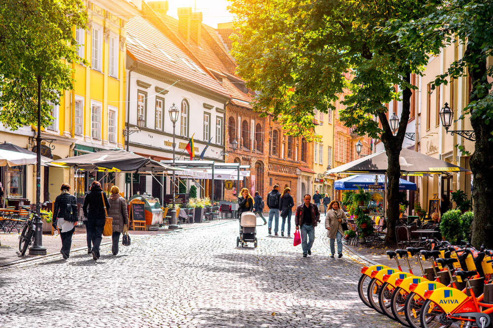 Why is Lithuania allowing small cafes to set up their tables in public spaces?