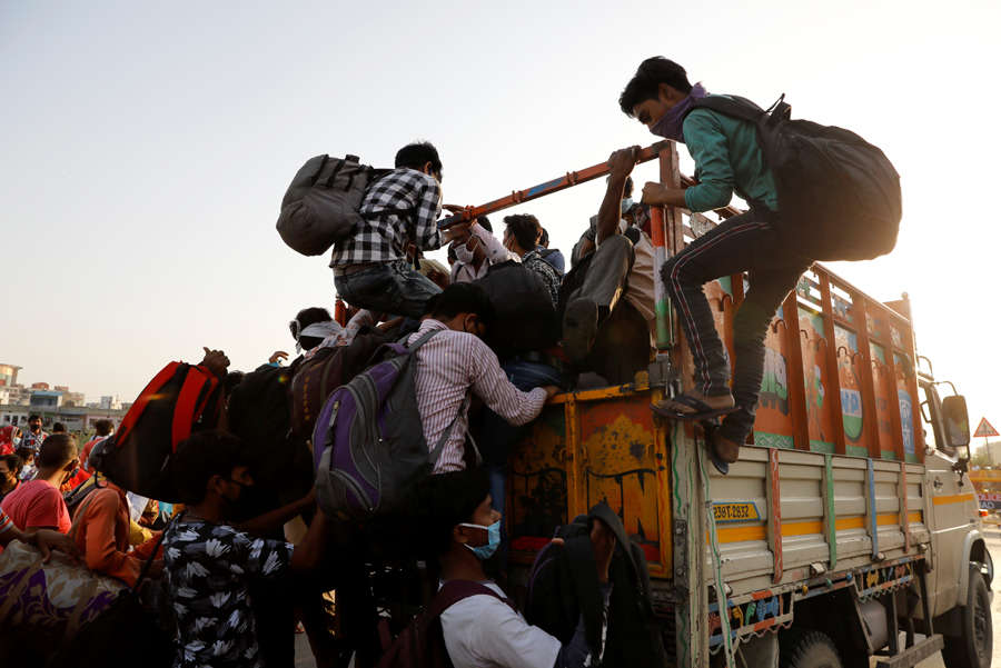 In pics: Stranded migrant workers desperate to return home
