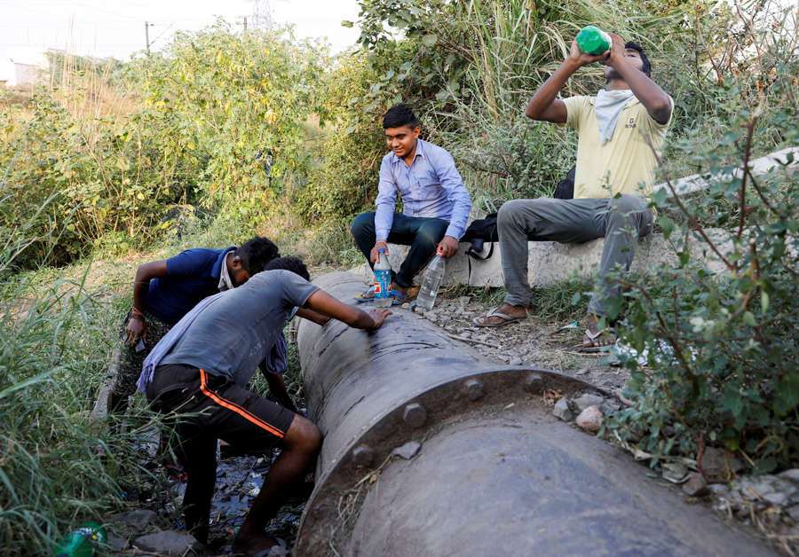 In pics: Stranded migrant workers desperate to return home