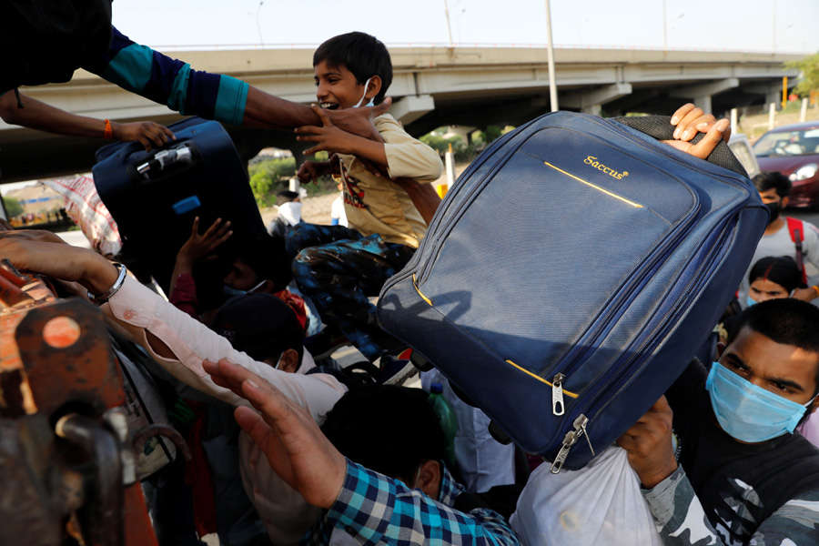 In pics: Stranded migrant workers desperate to return home