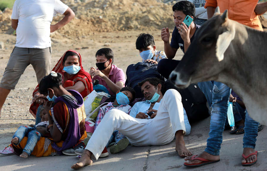 In pics: Stranded migrant workers desperate to return home