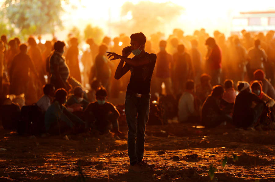 In pics: Stranded migrant workers desperate to return home