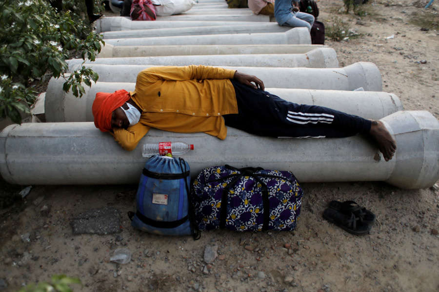 In pics: Stranded migrant workers desperate to return home