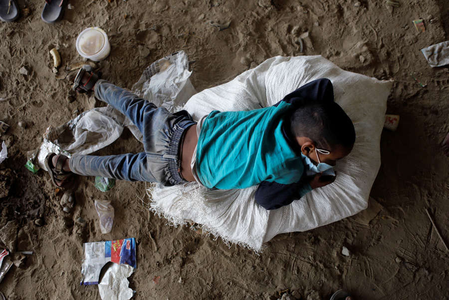 In pics: Stranded migrant workers desperate to return home