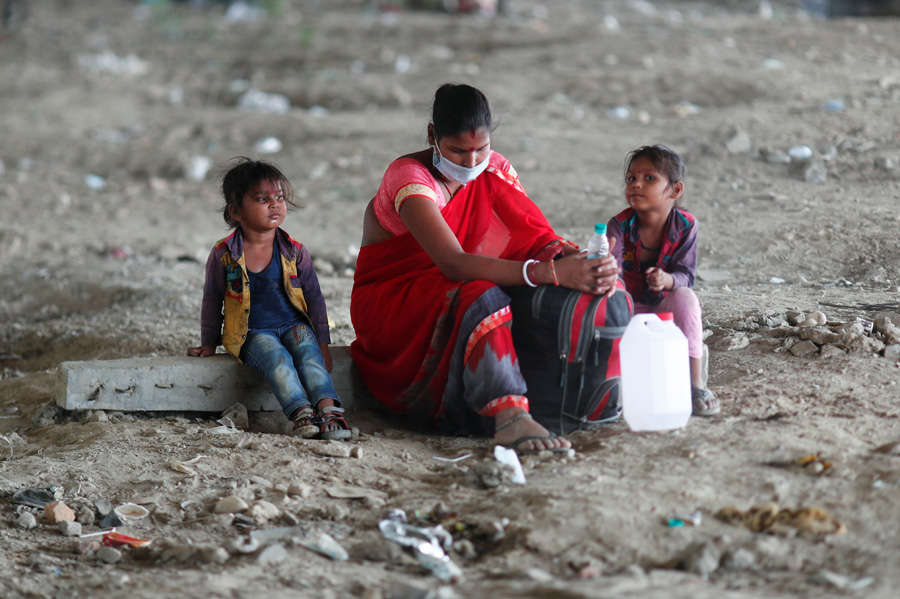 In pics: Stranded migrant workers desperate to return home