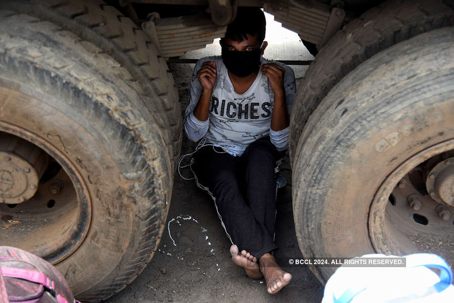 In pics: Stranded migrant workers desperate to return home