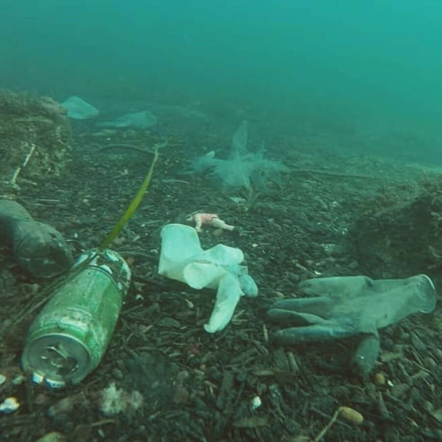 Masks and gloves wash up on the shores of the ocean