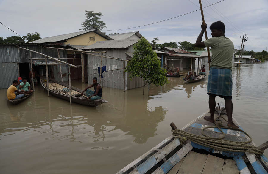 Flood affected villagers and cattle take shelter on a partially washed ...