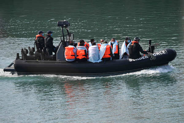 Migrants cross Channel in dinghies to England