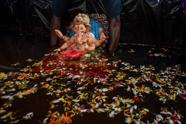 Devotees immerse idols of Lord Ganesha