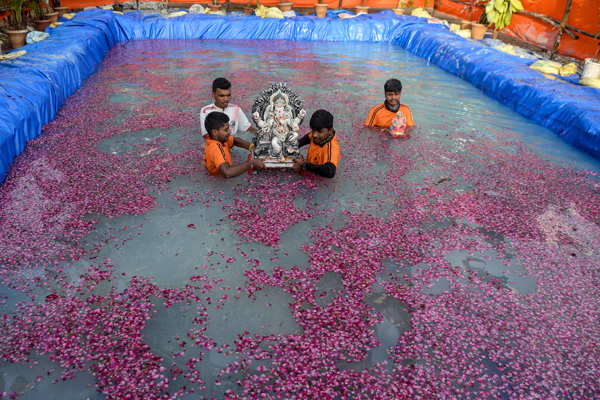 Devotees immerse idols of Lord Ganesha