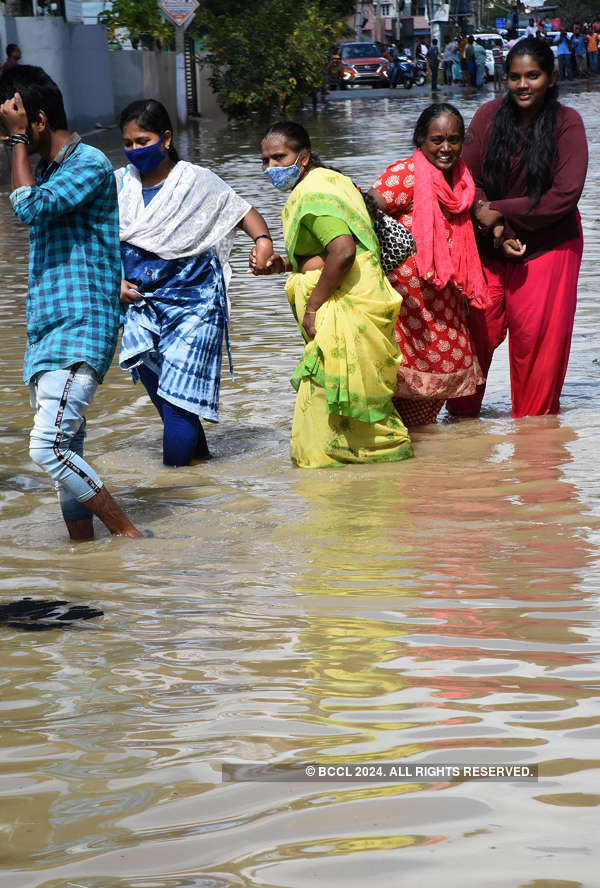 Local Residents Wade Through The Water After A Heavy Rain In Bengaluru ...