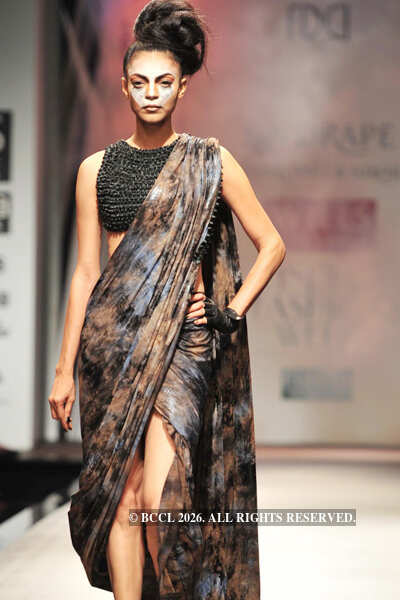 A model showcases a creation by designers Shantanu and Nikhil on Day 3 ...