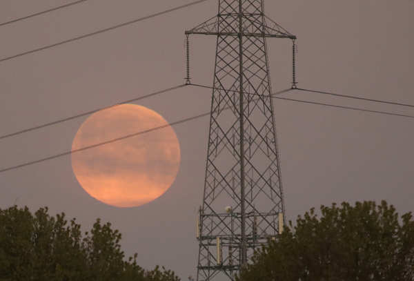 Spectacular pictures of 'pink' supermoon across the world