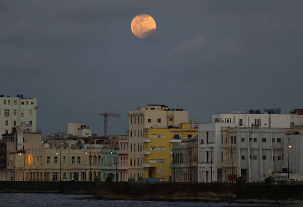 Spectacular pictures of 'pink' supermoon across the world