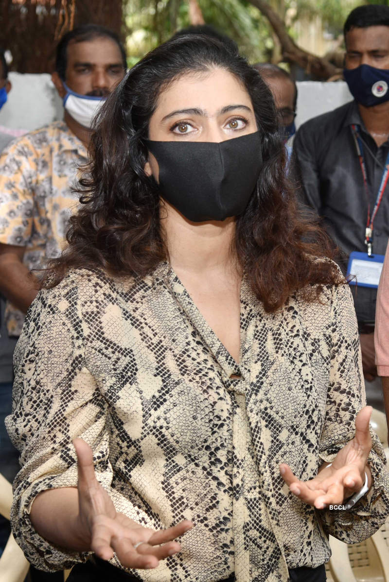 Bollywood actress Kajol distributes raincoats to BMC employees