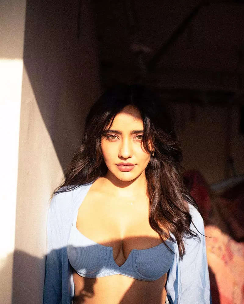 Neha Sharma oozes oomph in a blue bralette and an unbuttoned shirt in these  new drool-worthy pictures