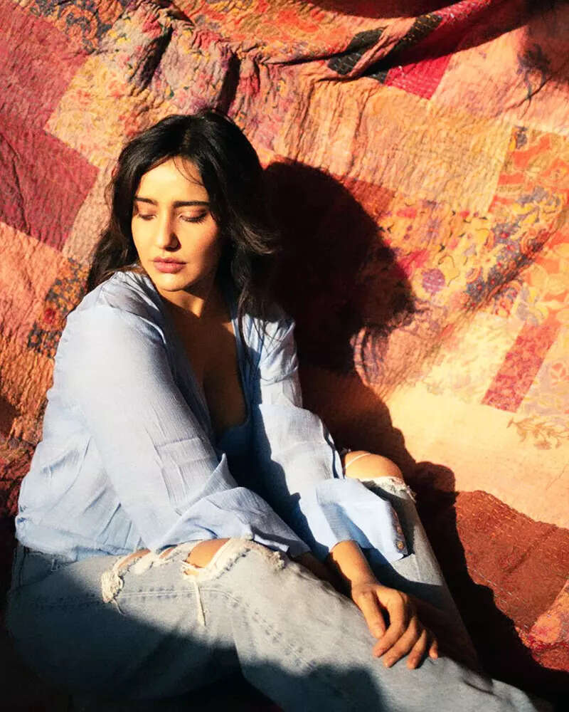 Neha Sharma oozes oomph in a blue bralette and an unbuttoned shirt in these new drool-worthy pictures