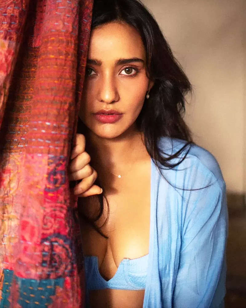 Neha Sharma oozes oomph in a blue bralette and an unbuttoned shirt in these new drool-worthy pictures