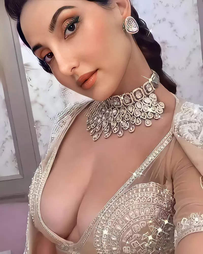 Nora Fatehi sets the internet on fire in a pearl deep-neck bralette and  thigh-slit skirt for latest photos. See here