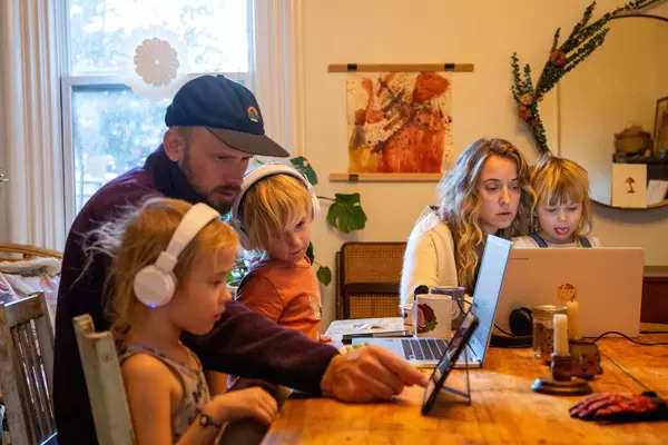 These pictures show how parents and children manage work and online school from home