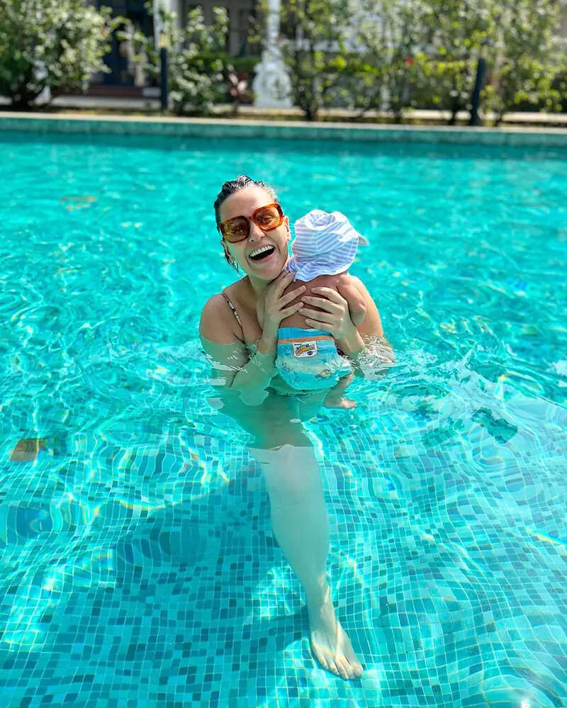 Lovely pictures of Neha Dhupia chilling with her little son in a pool will surely make your day