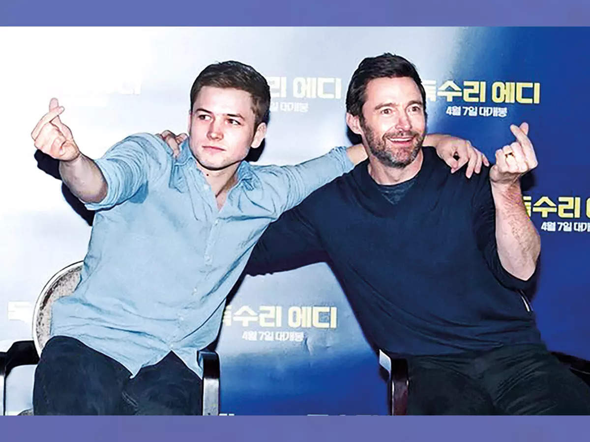 Taron Egerton and Hugh Jackman posed with finger hearts when they visited Korea