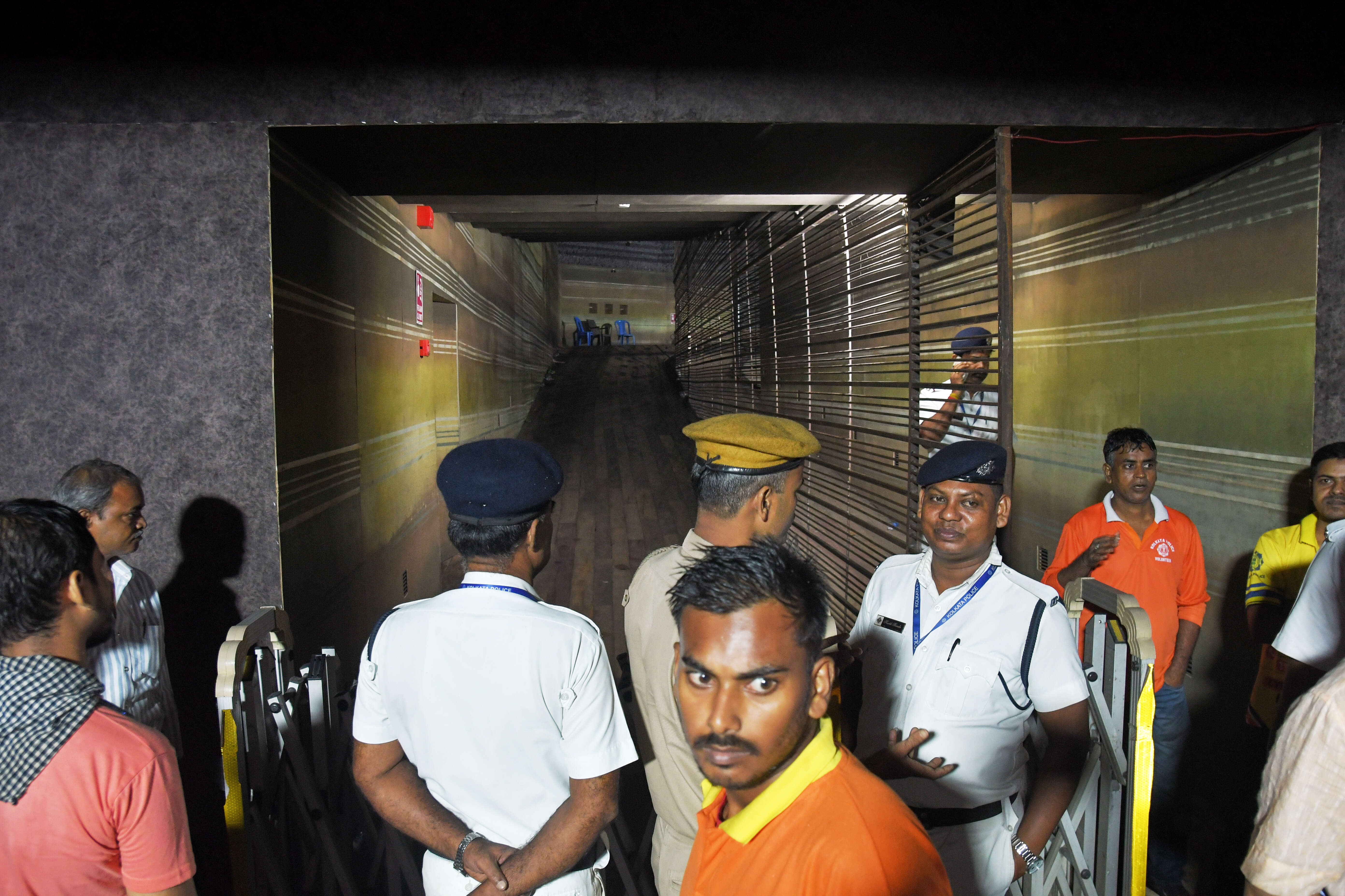 Police officers stand guard at the closed entrance to a worship venue for the Hindu festival of Durga Puja following a stampede, in Kolkata, India, Saturday