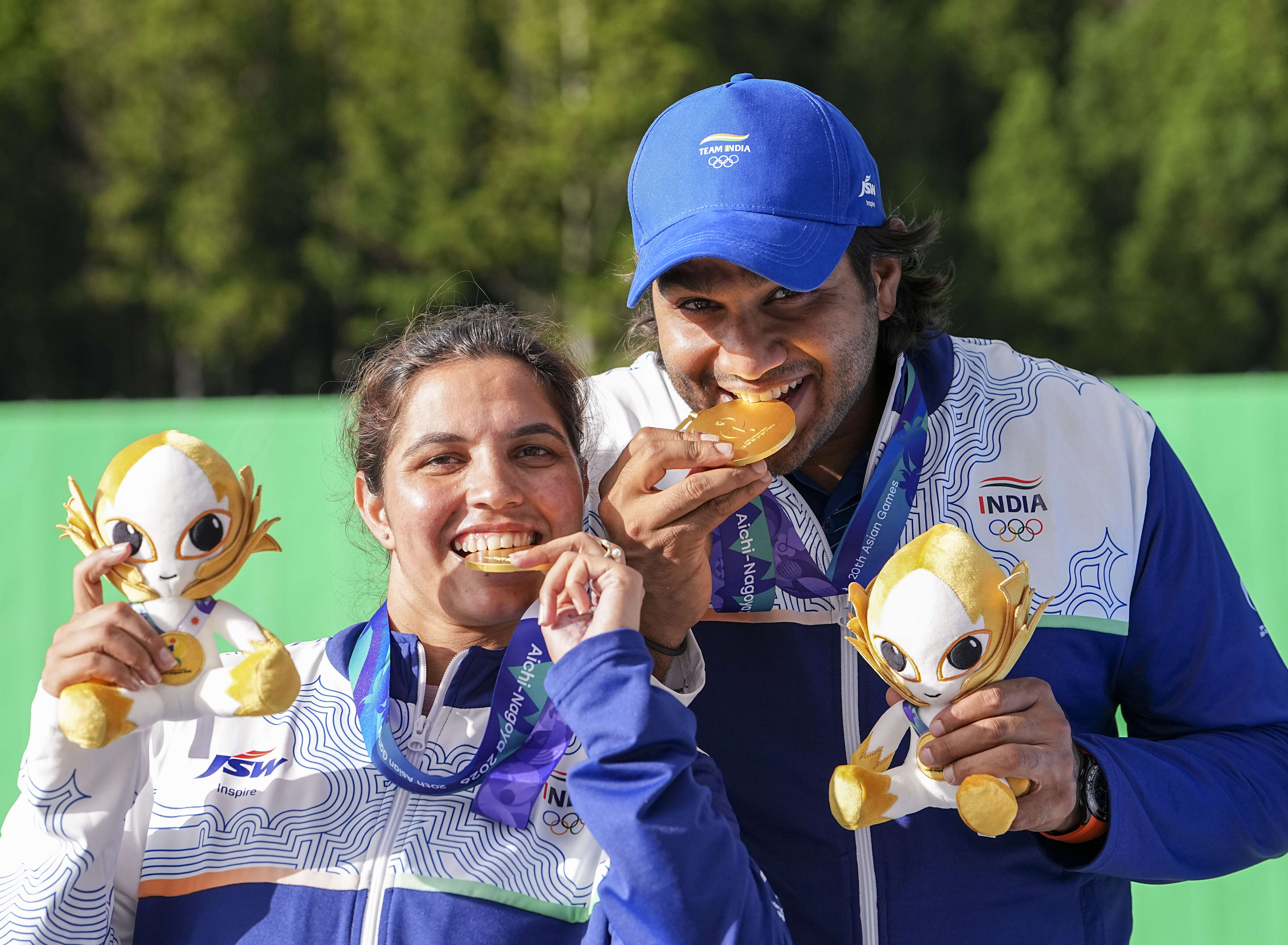 Gold medallist India's Neeru Dhanda, left, and Kynan Chenai pose for photographers during the medal ceremony after the trap mixed team shooting event at the 20th Asian Games, in Nagoya, Japan