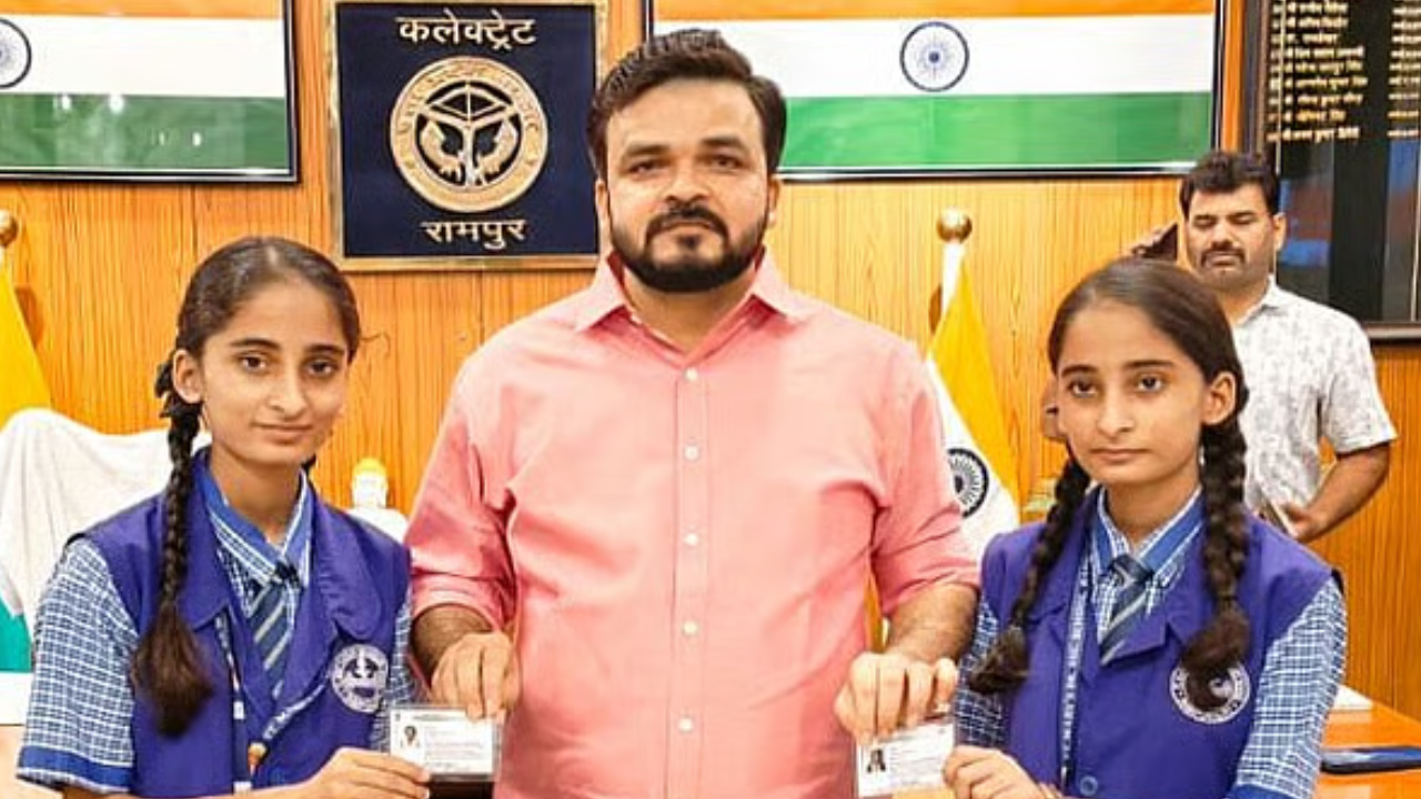 DM of Rampur with the twins and thier newly issued Aadhaar cards.