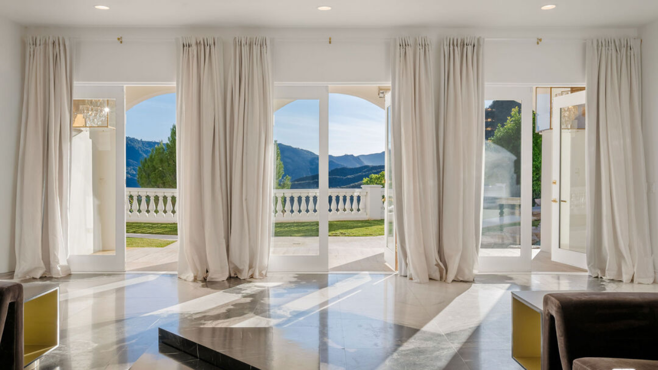 The two-storey residence features soaring ceilings, expansive windows and views of the surrounding mountains and valley<br>