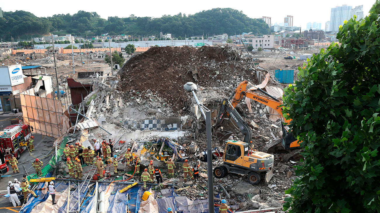Firefighters search for survivors following a collapsed building in Gwangju, South Korea,Wednesday, June 9, 2021.