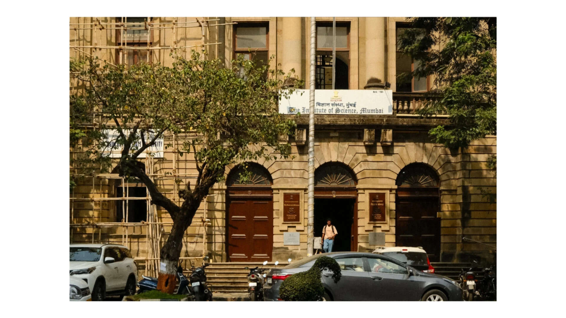 Scaffolding on the Institute of Science, a student in the archway, and enough shadow to test a sensor.