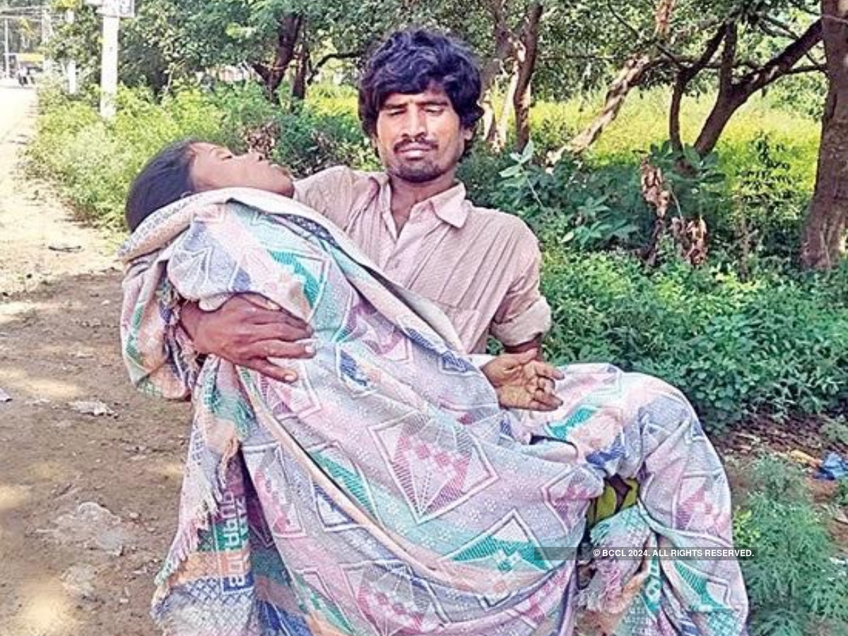 Andhra Pradesh Ragpicker carries wifes dead body in his arms for fune image